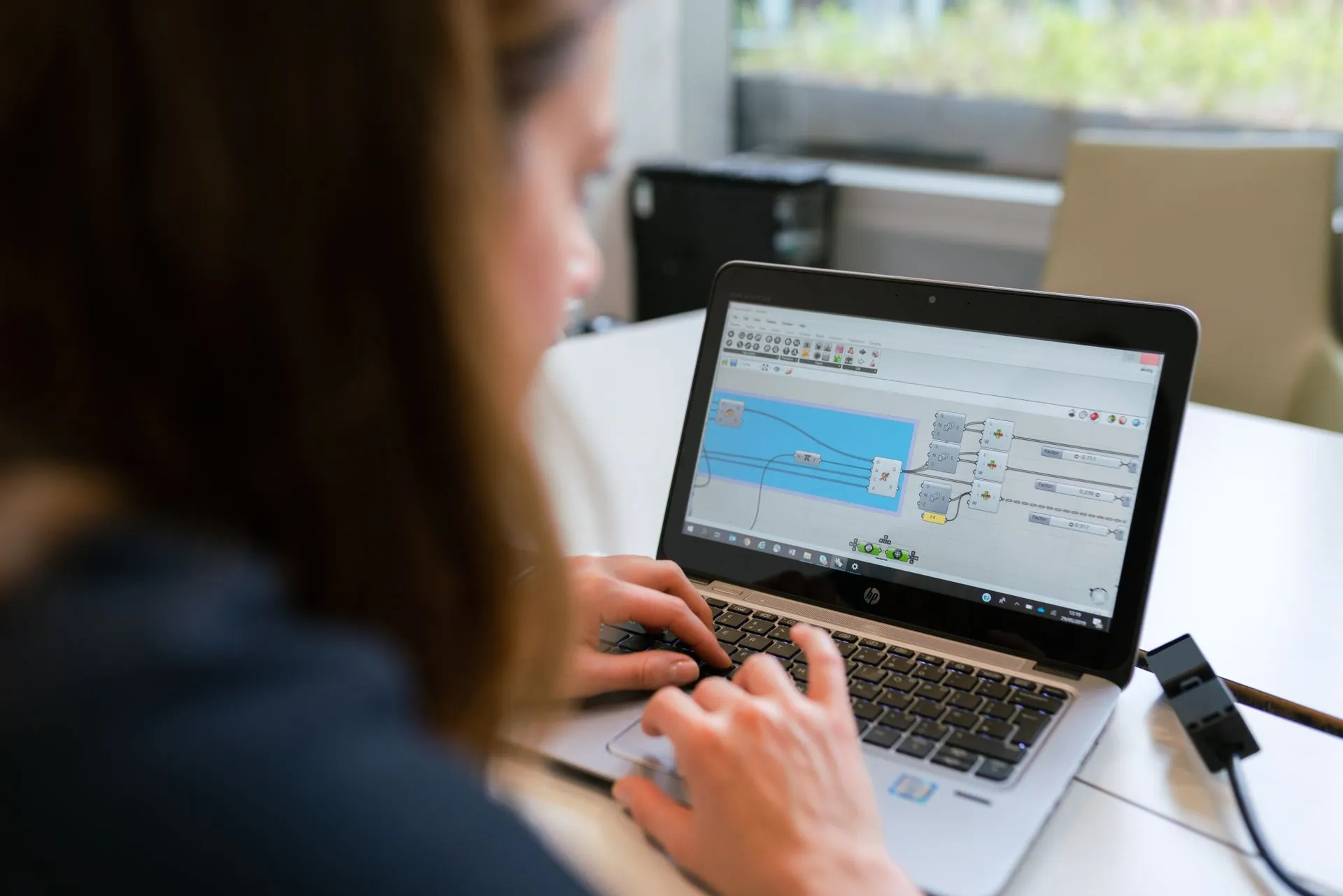 Engineer working at a laptop in a modern enterprise workspace